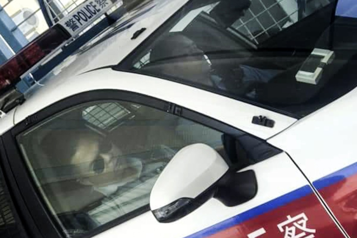 Two police constables were pictured sleeping in a police car while on duty in Kwai Chung on Tuesday morning. Photo: Facebook