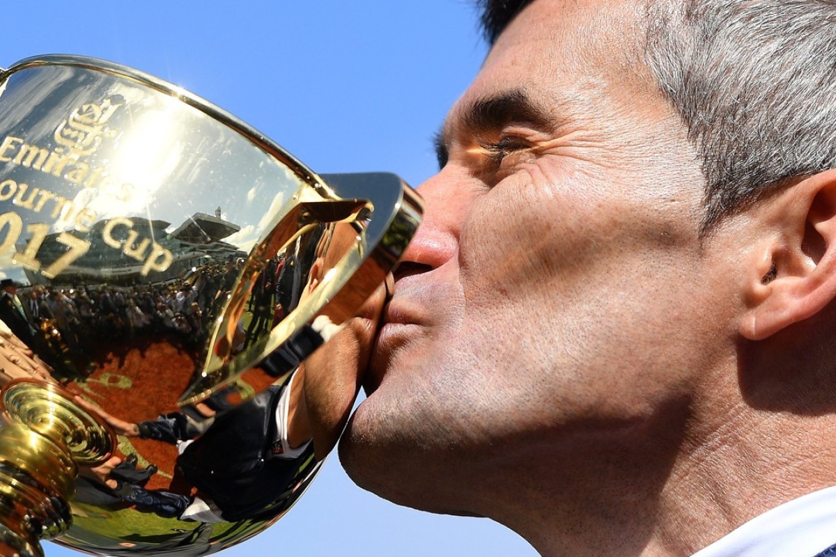 Jockey Corey Brown kisses the 2017 Melbourne Cup after winning aboard Rekindling. Photo: EPA